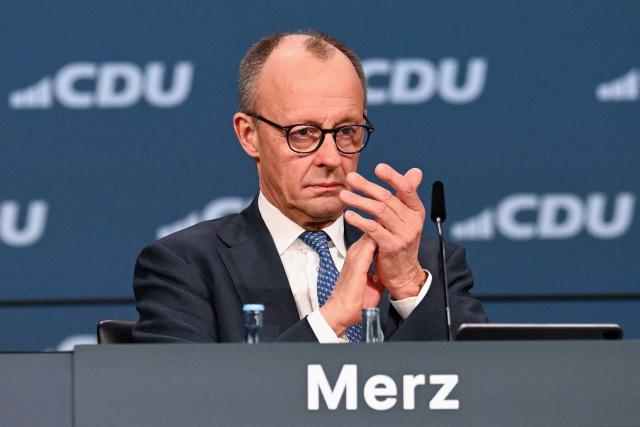 German Chancellor and Chairman of the Christian Democratic Party (CDU) Friedrich Merz, applauds during the CDU party Congress at the fair grounds in Stuttgart, southern Germany, on February 20, 2026. (Photo by THOMAS KIENZLE / AFP)