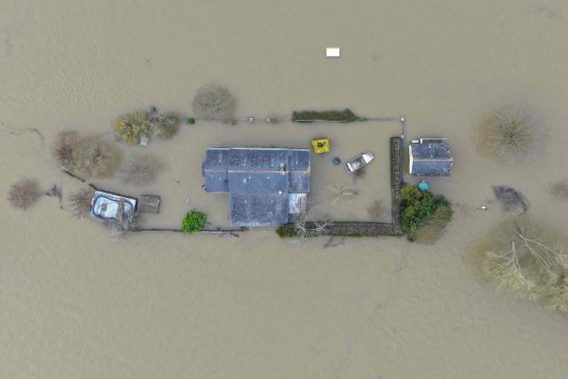 Aerial view of the Sarthe River overflowing and covering houses in the village of Cheffes, western France, on February 20, 2026. (Photo by Damien MEYER / AFP)