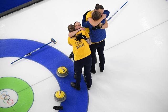 Sweden's Anna Hasselborg, Sweden's Sara McManus, Sweden's Agnes Knochenhauer and Sweden's Sofia Scharback celebrate after winning the curling women's round robin semi-final between Canada and Sweden during the Milano Cortina 2026 Winter Olympic Games at the Cortina Curling Olympic Stadium in Cortina d’Ampezzo on February 20, 2026. (Photo by Antonin THUILLIER / AFP)