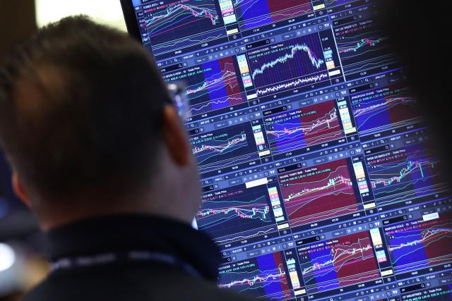 A trader works at the opening bell on the floor of the New York Stock Exchange (NYSE) in New York, on February 20, 2026. Wall Street stocks mostly fell early Friday following data showing disappointing US economic growth and an uptick in inflation. (Photo by TIMOTHY A. CLARY / AFP)