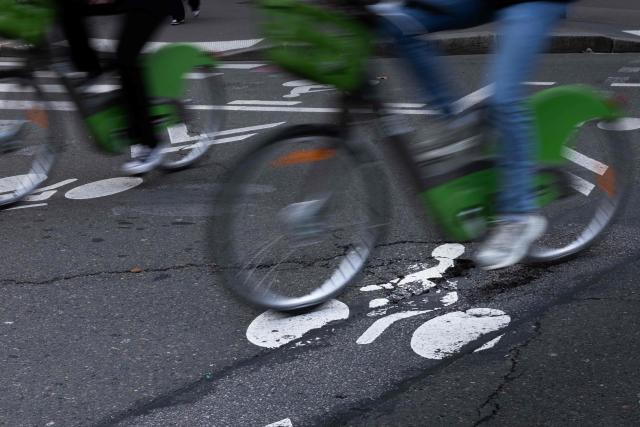A cyclist ride over a pothole on a cycle path in central Paris on February 20, 2026. (Photo by JOEL SAGET / AFP)
