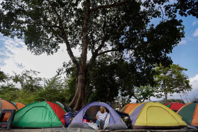 A relative of a political prisoners sits in a tent in front of El Rodeo I prison in Guatire, Miranda state, Venezuela, on February 20, 2026. Venezuela's National Assembly on February 19 unanimously approved a long-awaited amnesty law that could free hundreds of political prisoners jailed for being government detractors. (Photo by Pedro MATTEY / AFP)