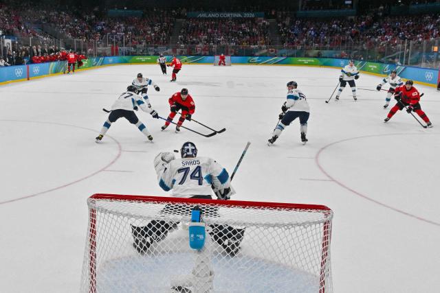 Finland's #74 Juuse Saros makes a save on a shot from Canada's #09 Sam Bennett during the men's play-off semi-final ice hockey match between Canada and Finland at the Milano Santagiulia Ice Hockey Arena during the Milano Cortina 2026 Winter Olympic Games in Milan, on February 20, 2026. (Photo by JULIEN DE ROSA / POOL / AFP)