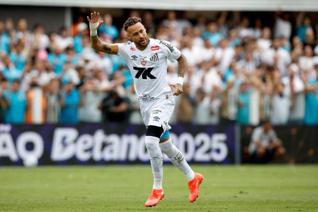 (FILES) Santos' forward Neymar greets fans while warming up before the Brasileirao Serie A football match between Santos and Cruzeiro at the Urbano Caldeira Stadium in Santos, Sao Paulo state, Brazil on December 7, 2025. Brazilian football star Neymar admitted for the first time that he could end his career at the end of 2026, just months before the World Cup he still hopes to play with the Selecao. (Photo by Miguel Schincariol / AFP)