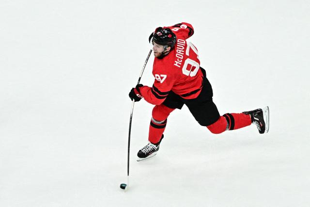 Canada's #97 Connor Mcdavid shoots the puck  during the men's play-off semi-final ice hockey match between Canada and Finland at the Milano Santagiulia Ice Hockey Arena during the Milano Cortina 2026 Winter Olympic Games in Milan, on February 20, 2026. (Photo by JULIEN DE ROSA / AFP)