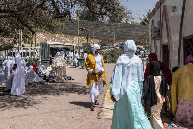 Muslims arrive ahead of the first Friday prayer of the holy month of Ramadan at the Mosque of the Divinity in Dakar, on February 20, 2026. (Photo by PATRICK MEINHARDT / AFP)
