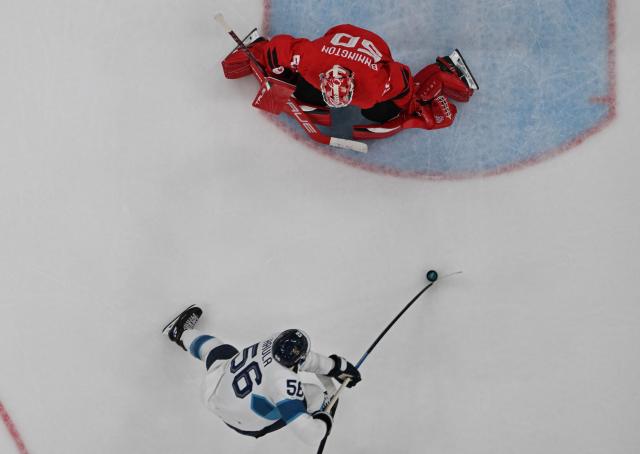 Finland's #56 Erik Haula (bottom) scores their second goal past Canada's #50 Jordan Binnington during the men's play-off semi-final ice hockey match between Canada and Finland at the Milano Santagiulia Ice Hockey Arena during the Milano Cortina 2026 Winter Olympic Games in Milan, on February 20, 2026. (Photo by JULIEN DE ROSA / AFP)