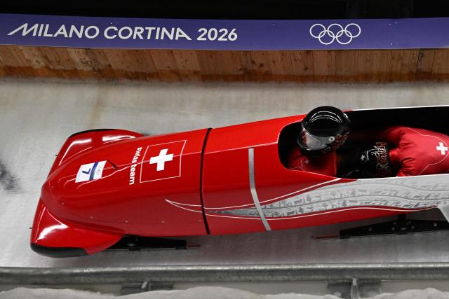 Switzerland's Melanie Hasler and Switzerland's Nadja Pasternack compete in the women's bobsleigh 2-woman heat 1 at Cortina Sliding Centre during the Milano Cortina 2026 Winter Olympic Games in Cortina d'Ampezzo on February 20, 2026. (Photo by Tiziana FABI / AFP)