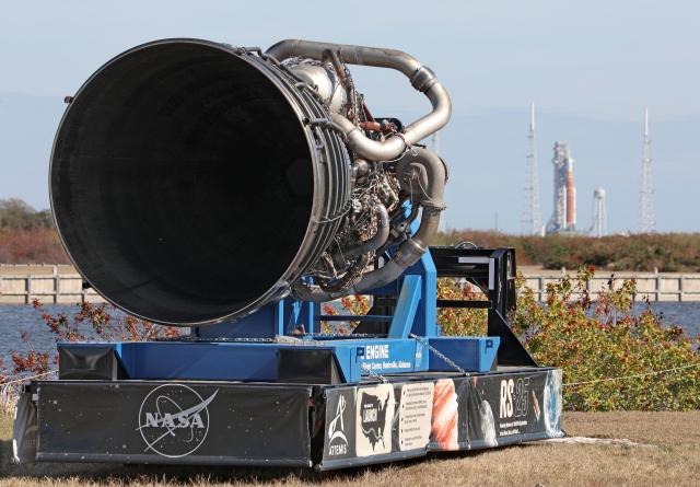 One of the massive RS-25 engines for NASA's Artemis II Space Launch System (SLS) rocket is displayed near the countdown clock at Kennedy Space Center in Cape Canaveral, Florida, on February 20, 2026. NASA performed their second wet dress rehearsal prior to sending four astronauts to the moon for the first time in more than 50 years. NASA officials said they are targeting March 6 for the crewed flight to the moon. (Photo by Gregg Newton / AFP)