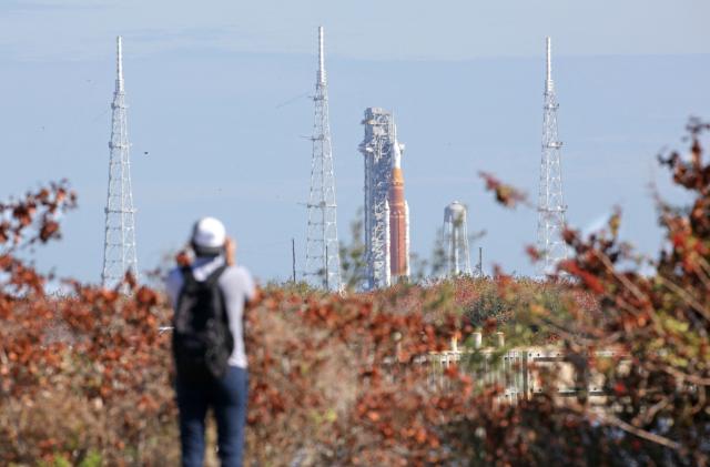 NASA's Artemis II Space Launch System (SLS) rocket and Orion spacecraft are seen in the distance at Launch Pad 39B at Kennedy Space Center in Cape Canaveral, Florida, on February 20, 2026. NASA performed their second wet dress rehearsal prior to sending four astronauts to the moon for the first time in more than 50 years. NASA officials said they are targeting March 6 for the crewed flight to the moon. (Photo by Gregg Newton / AFP)
