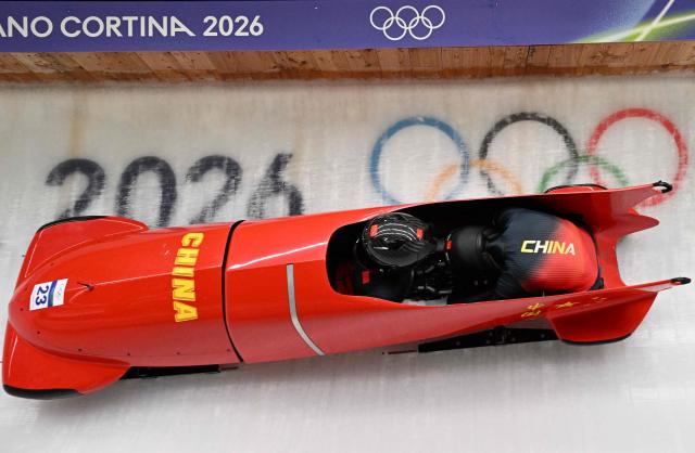 China's Ying Qing and China's Wang Yu compete in the women's bobsleigh 2-woman heat 1 at Cortina Sliding Centre during the Milano Cortina 2026 Winter Olympic Games in Cortina d'Ampezzo on February 20, 2026. (Photo by Tiziana FABI / AFP)