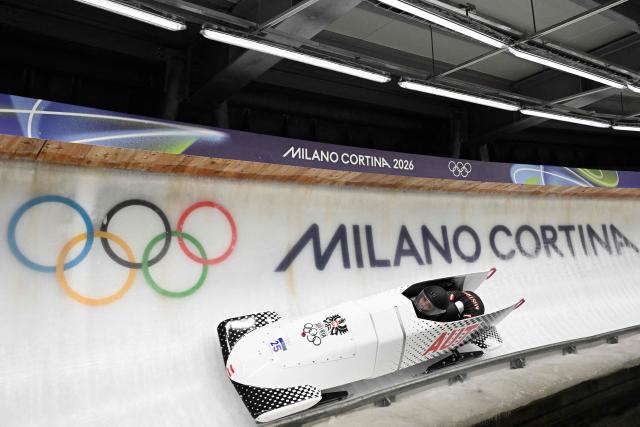 Austria's Lea Haslwanter and Austria's Victoria Festin compete in the women's bobsleigh 2-woman heat 1 at Cortina Sliding Centre during the Milano Cortina 2026 Winter Olympic Games in Cortina d'Ampezzo on February 20, 2026. (Photo by Tiziana FABI / AFP)