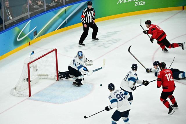 Finland's #74 Juuse Saros (L)makes a save during the men's play-off semi-final ice hockey match between Canada and Finland at the Milano Santagiulia Ice Hockey Arena during the Milano Cortina 2026 Winter Olympic Games in Milan, on February 20, 2026. (Photo by JULIEN DE ROSA / AFP)