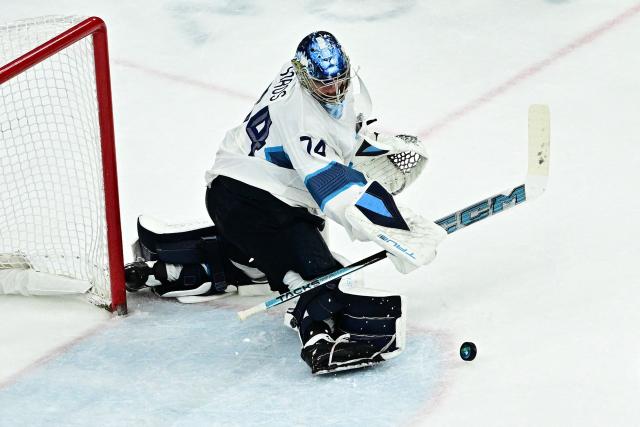 Finland's #74 Juuse Saros makes a save during the men's play-off semi-final ice hockey match between Canada and Finland at the Milano Santagiulia Ice Hockey Arena during the Milano Cortina 2026 Winter Olympic Games in Milan, on February 20, 2026. (Photo by JULIEN DE ROSA / AFP)