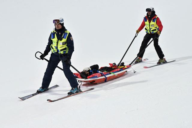 South Korea's Lee Seunghun is evacuated after crashing while warming up in the freestyle skiing men's freeski halfpipe final run 1 during the Milano Cortina 2026 Winter Olympic Games at Livigno Snow Park, in Livigno (Valtellina), on February 20, 2026. (Photo by Jeff PACHOUD / AFP)