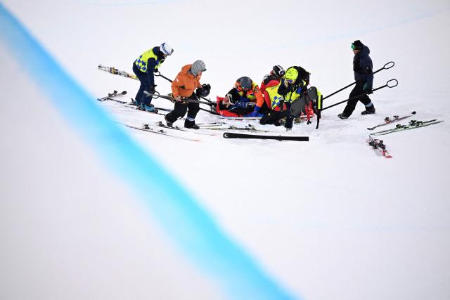 South Korea's Lee Seunghun is evacuated after crashing while warming up in the freestyle skiing men's freeski halfpipe final run 1 during the Milano Cortina 2026 Winter Olympic Games at Livigno Snow Park, in Livigno (Valtellina), on February 20, 2026. (Photo by Kirill KUDRYAVTSEV / AFP)