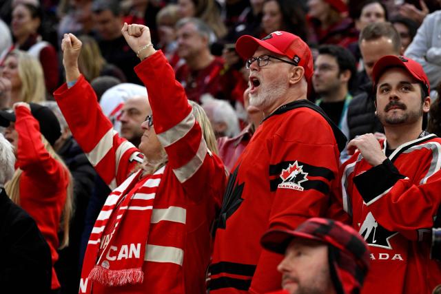 Canada fans celebrate during the men's play-off semi-final ice hockey match between Canada and Finland at the Milano Santagiulia Ice Hockey Arena during the Milano Cortina 2026 Winter Olympic Games in Milan, on February 20, 2026. (Photo by Alexander NEMENOV / AFP)