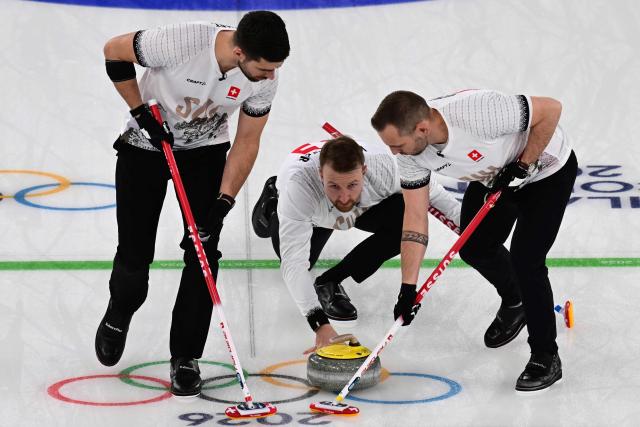 Switzerland's Pablo Lachat-Couchepin, Switzerland's Yannick Schwaller and Switzerland's Sven Michel compete in the curling men's round robin bronze medal game between Norway and Switzerland during the Milano Cortina 2026 Winter Olympic Games at the Cortina Curling Olympic Stadium in Cortina d’Ampezzo on February 20, 2026. (Photo by Stefano RELLANDINI / AFP)