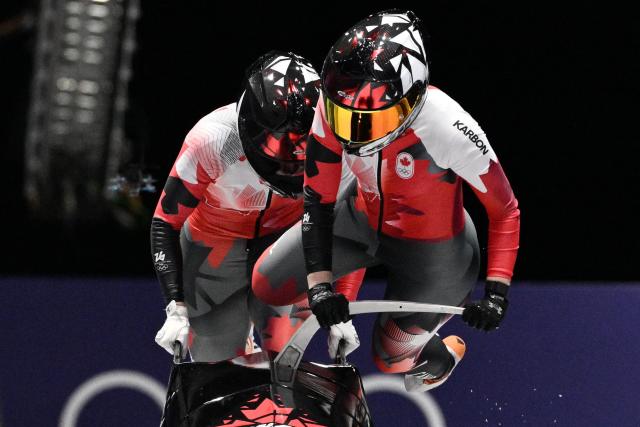 Canada's Bianca Ribi and Canada's Skylar Sieben compete in the women's bobsleigh 2-woman heat 2 at Cortina Sliding Centre during the Milano Cortina 2026 Winter Olympic Games in Cortina d'Ampezzo on February 20, 2026. (Photo by Tiziana FABI / AFP)