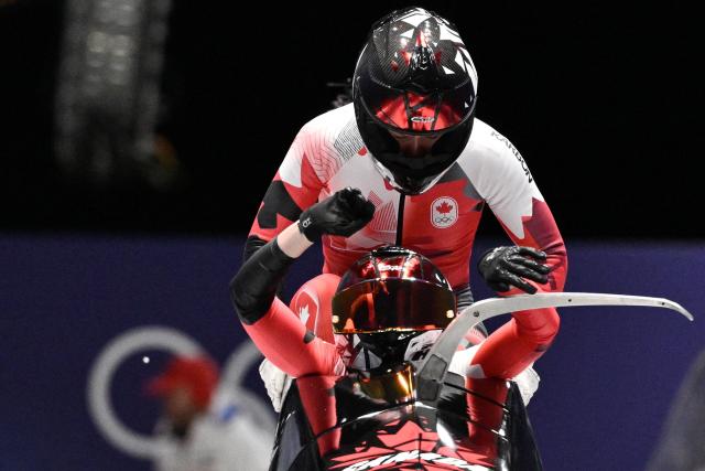 Canada's Bianca Ribi and Canada's Skylar Sieben compete in the women's bobsleigh 2-woman heat 2 at Cortina Sliding Centre during the Milano Cortina 2026 Winter Olympic Games in Cortina d'Ampezzo on February 20, 2026. (Photo by Tiziana FABI / AFP)