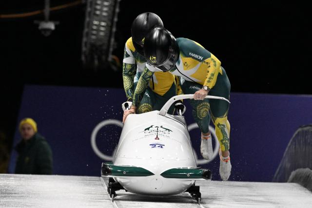 Australia's Bree Walker and Australia's Kiara Reddingius compete in the women's bobsleigh 2-woman heat 2 at Cortina Sliding Centre during the Milano Cortina 2026 Winter Olympic Games in Cortina d'Ampezzo on February 20, 2026. (Photo by Tiziana FABI / AFP)