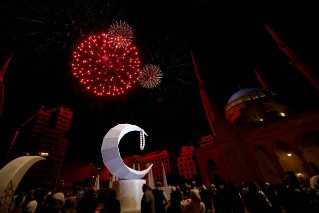 Fireworks illuminate the sky in celebration of the start of the holy Muslim month of Ramadan in downtown Beirut on February 20, 2026. Muslims throughout the world are marking the month of Ramadan, the holiest month in the Islamic calendar, during which devotees fast from dawn until dusk. (Photo by Anwar AMRO / AFP)