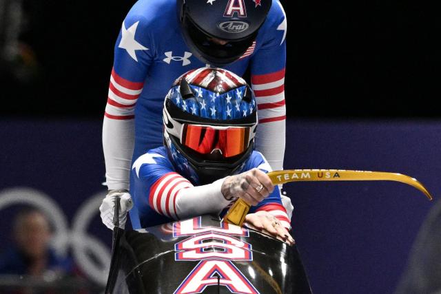 USA's Kaillie Armbruster Humphries and USA's Jasmine Jones compete in the women's bobsleigh 2-woman heat 2 at Cortina Sliding Centre during the Milano Cortina 2026 Winter Olympic Games in Cortina d'Ampezzo on February 20, 2026. (Photo by Tiziana FABI / AFP)