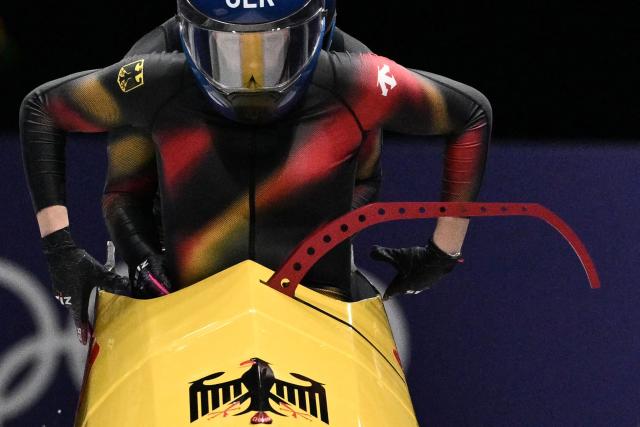 Germany's Laura Nolte and Germany's Deborah Levi compete in the women's bobsleigh 2-woman heat 2 at Cortina Sliding Centre during the Milano Cortina 2026 Winter Olympic Games in Cortina d'Ampezzo on February 20, 2026. (Photo by Tiziana FABI / AFP)