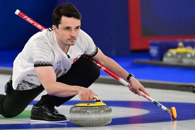 Switzerland's Benoit Schwarz-Van Berkel competes in the curling men's round robin bronze medal game between Norway and Switzerland during the Milano Cortina 2026 Winter Olympic Games at the Cortina Curling Olympic Stadium in Cortina d’Ampezzo on February 20, 2026. (Photo by Stefano RELLANDINI / AFP)