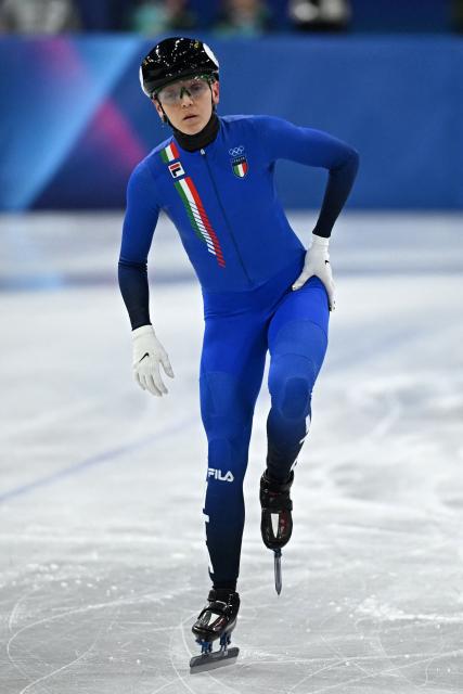Italy's Arianna Fontana touches her hip after a crash in the short track speed skating women's 1500m quarter-final during the Milano Cortina 2026 Winter Olympic Games at Milano Ice Skating Arena in Milan on February 20, 2026. (Photo by Gabriel BOUYS / AFP)