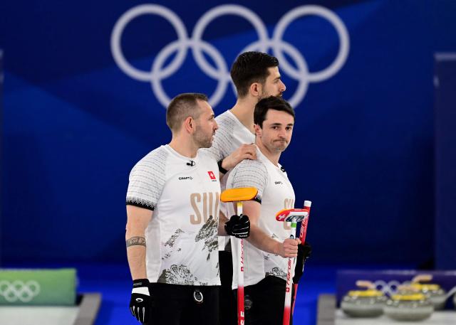 Switzerland's Sven Michel, Switzerland's Pablo Lachat-Couchepin and Switzerland's Benoit Schwarz-van Berkel react during the curling men's round robin bronze medal game between Norway and Switzerland during the Milano Cortina 2026 Winter Olympic Games at the Cortina Curling Olympic Stadium in Cortina d’Ampezzo on February 20, 2026. (Photo by Stefano RELLANDINI / AFP)