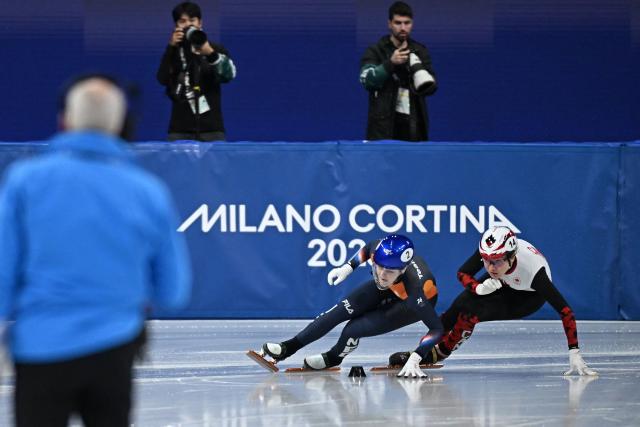 Netherlands' Xandra Velzeboer and Canada's Courtney Sarault compete in the short track speed skating women's 1500m final B during the Milano Cortina 2026 Winter Olympic Games at Milano Ice Skating Arena in Milan on February 20, 2026. (Photo by Gabriel BOUYS / AFP)