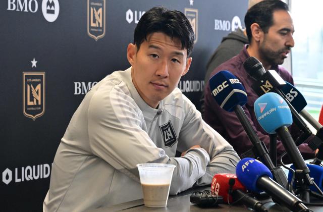 Los Angeles Football Club's South Korean player Son Heung-min (L) looks on during a press conference at The Liquid I.V. Performance Center on the campus of Cal State LA in Los Angeles on February 20, 2026. LAFC will play against Miami during the MLS opening match on February 21. (Photo by Frederic J. Brown / AFP)