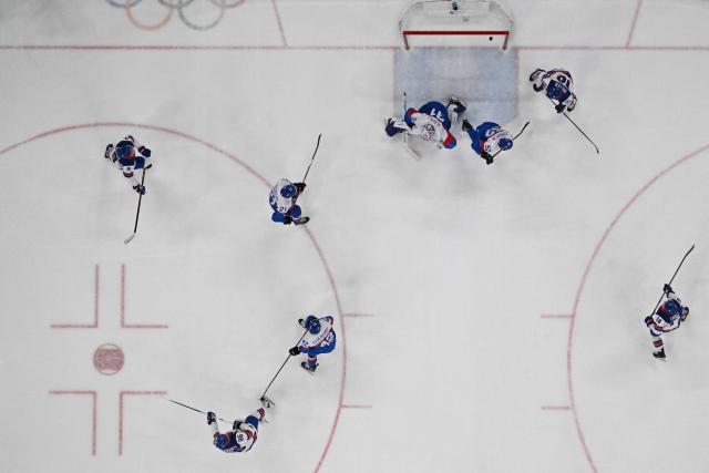 USA's #86 Jack Hughes (down) scores a goal  during the men's play-off semi-final ice hockey match between USA and Slovakia at the Milano Santagiulia Ice Hockey Arena during the Milano Cortina 2026 Winter Olympic Games in Milan, on February 20, 2026. (Photo by JULIEN DE ROSA / POOL / AFP)