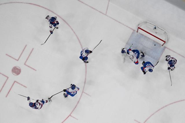 USA's #86 Jack Hughes (down) scores a goal  during the men's play-off semi-final ice hockey match between USA and Slovakia at the Milano Santagiulia Ice Hockey Arena during the Milano Cortina 2026 Winter Olympic Games in Milan, on February 20, 2026. (Photo by JULIEN DE ROSA / POOL / AFP)