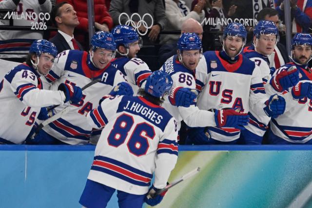 USA's #86 Jack Hughes celebrates with teammates after scoring his team's third goal during the men's play-off semi-final ice hockey match between USA and Slovakia at the Milano Santagiulia Ice Hockey Arena during the Milano Cortina 2026 Winter Olympic Games in Milan, on February 20, 2026. (Photo by Alexander NEMENOV / AFP)