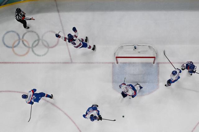 USA's players celebrate a goal  during the men's play-off semi-final ice hockey match between USA and Slovakia at the Milano Santagiulia Ice Hockey Arena during the Milano Cortina 2026 Winter Olympic Games in Milan, on February 20, 2026. (Photo by JULIEN DE ROSA / AFP)