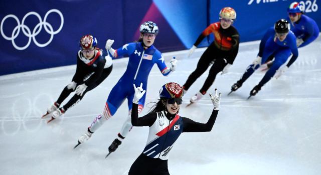 South Korea's Kim Gil-li (front) celebrates after winning gold in the short track speed skating women's 1500m final during the Milano Cortina 2026 Winter Olympic Games at Milano Ice Skating Arena in Milan on February 20, 2026. (Photo by WANG Zhao / AFP)