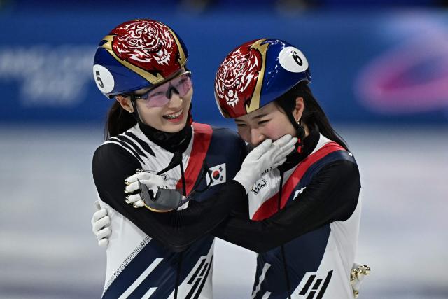 Gold medallist South Korea's Kim Gil-li (R) and silver medallist South Korea's Choi Min-jeong hug after the short track speed skating women's 1500m final during the Milano Cortina 2026 Winter Olympic Games at Milano Ice Skating Arena in Milan on February 20, 2026. (Photo by Gabriel BOUYS / AFP)