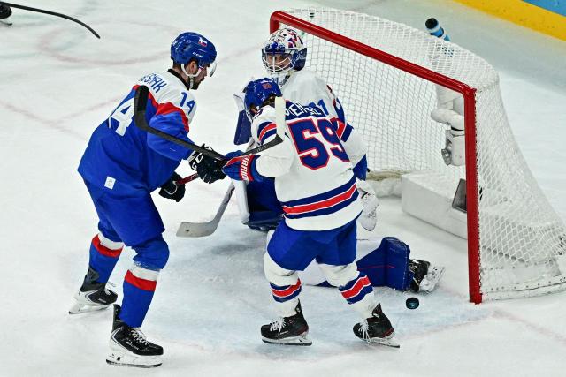 USA's #59 Jake Guentzel deflects the puck with his skate for a goal which was disallowed during the men's play-off semi-final ice hockey match between USA and Slovakia at the Milano Santagiulia Ice Hockey Arena during the Milano Cortina 2026 Winter Olympic Games in Milan, on February 20, 2026. (Photo by JULIEN DE ROSA / AFP)