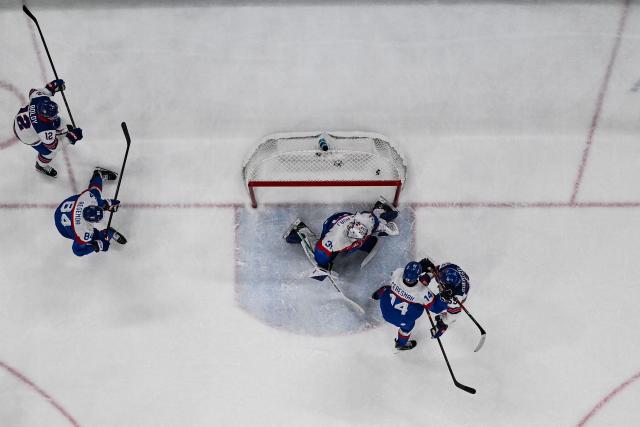 Slovakia's #31 Samuel Hlavaj (C) concedes a goal  during the men's play-off semi-final ice hockey match between USA and Slovakia at the Milano Santagiulia Ice Hockey Arena during the Milano Cortina 2026 Winter Olympic Games in Milan, on February 20, 2026. (Photo by JULIEN DE ROSA / POOL / AFP)