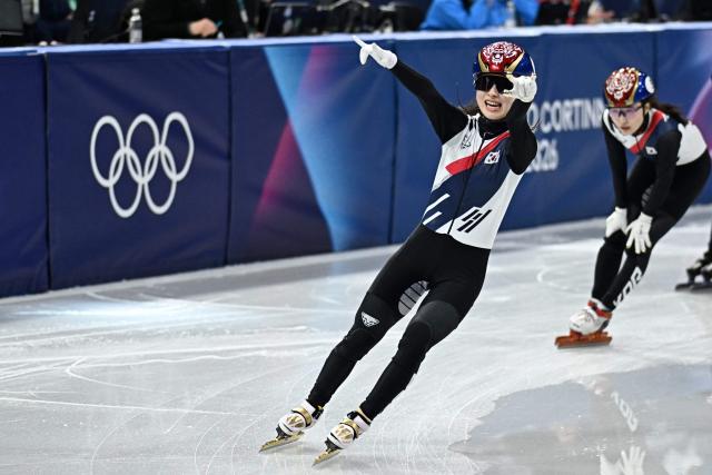 South Korea's Kim Gil-li celebrates after crossing the finish line to win gold ahead of silver medallist South Korea's Choi Min-jeong in the short track speed skating women's 1500m final during the Milano Cortina 2026 Winter Olympic Games at Milano Ice Skating Arena in Milan on February 20, 2026. (Photo by Gabriel BOUYS / AFP)