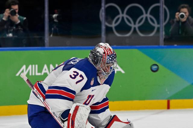 USA's #37 Connor Hellebuyck saves the puck during the men's play-off semi-final ice hockey match between USA and Slovakia at the Milano Santagiulia Ice Hockey Arena during the Milano Cortina 2026 Winter Olympic Games in Milan, on February 20, 2026. (Photo by Alexander NEMENOV / AFP)