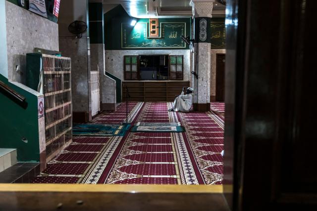 A Muslim prays after breaking fast during the first Friday of the holy month of Ramadan at the Mosque of the Divinity in Dakar, on February 20, 2026. Muslims throughout the world are marking the month of Ramadan, the holiest month in the Islamic calendar, during which devotees fast from dawn until dusk. (Photo by PATRICK MEINHARDT / AFP)