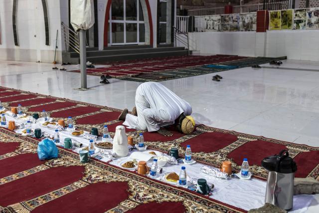 TOPSHOT - A Muslim prays after breaking fast during the first Friday of the holy month of Ramadan at the Mosque of the Divinity in Dakar, on February 20, 2026. Muslims throughout the world are marking the month of Ramadan, the holiest month in the Islamic calendar, during which devotees fast from dawn until dusk. (Photo by PATRICK MEINHARDT / AFP)