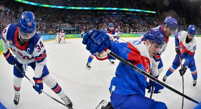 (From L) USA's #34 Auston Matthews, Slovakia's #20 Juraj Slafkovsky, USA's #14 Brock Faber and Slovakia's #90 Tomas Tatar vie for the puck during the men's play-off semi-final ice hockey match between USA and Slovakia at the Milano Santagiulia Ice Hockey Arena during the Milano Cortina 2026 Winter Olympic Games in Milan, on February 20, 2026. (Photo by Alexander NEMENOV / AFP)