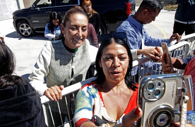 Mexico's President Claudia Sheinbaum (L) poses for a picture with a supporter as she leaves an event in Leon, Guanajuato state, Mexico, on February 20, 2026. Sheinbaum on February 20 called for the release of imprisoned former Peruvian president Pedro Castillo, following the appointment of a new head of state in the South American country earlier this week. (Photo by Mario Armas / AFP)