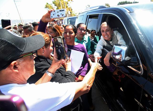 Mexico's President Claudia Sheinbaum greets supporters as she leaves an event in Leon, Guanajuato state, Mexico, on February 20, 2026. Sheinbaum on February 20 called for the release of imprisoned former Peruvian president Pedro Castillo, following the appointment of a new head of state in the South American country earlier this week. (Photo by Mario Armas / AFP)