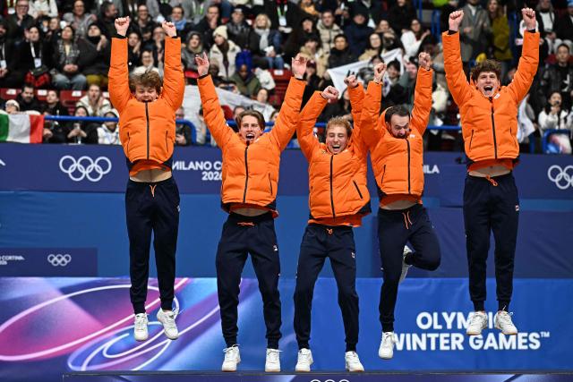 (From L) Gold medallists Netherlands' Melle van 't Wout, Netherlands' Jens van 't Wout, Netherlands' Friso Emons, Netherlands' Itzhak de Laat and Netherlands' Teun Boer jump as they arrive on the podium of the short track speed skating men's 5000m relay final during the Milano Cortina 2026 Winter Olympic Games at Milano Ice Skating Arena in Milan on February 20, 2026. (Photo by Gabriel BOUYS / AFP)