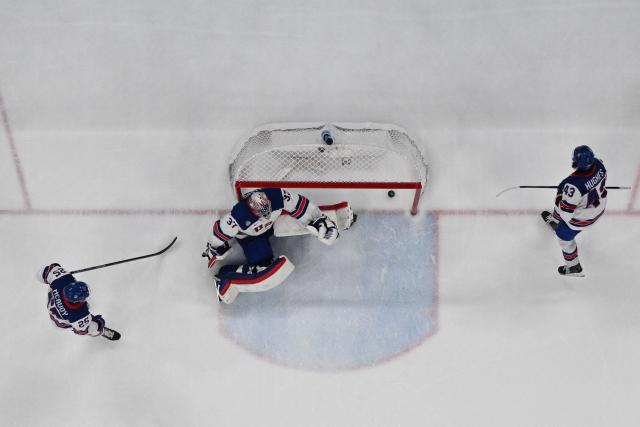 USA's #37 Connor Hellebuyck concedes a goal  during the men's play-off semi-final ice hockey match between USA and Slovakia at the Milano Santagiulia Ice Hockey Arena during the Milano Cortina 2026 Winter Olympic Games in Milan, on February 20, 2026. (Photo by JULIEN DE ROSA / AFP)